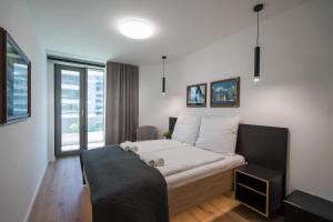 a bedroom with a bed with a teddy bear on it at MyFlat Wave Yacht Apartment in Siófok +37 photos