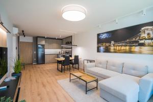 a living room with a white couch and a table at MyFlat Wave Yacht Apartment in Siófok