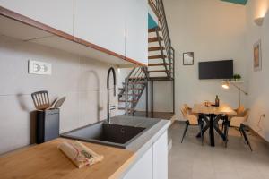 a kitchen and living room with a sink and a table at Villas Sole in Bol
