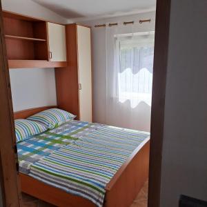 Postel nebo postele na pokoji v ubytování Apartments Cecilija