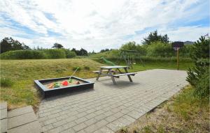 a park with a picnic table and a swing at Holiday Home Lakolk Iiv Denmark in Bolilmark +25 photos