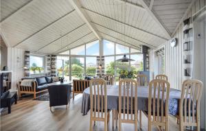 a dining room with a table and chairs at Holiday Home Lakolk Iiv Denmark in Bolilmark