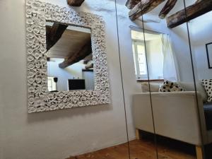 a mirror hanging on a wall in a room at Casa Grillino in Locarno +36 photos