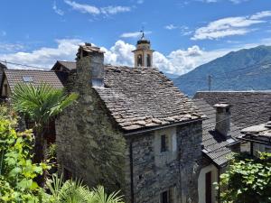 an old stone building with a clock tower on top of it at Casa Grillino in Locarno