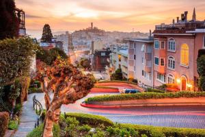 a view of a city at sunset with a tree at The Monarch Hotel in San Francisco