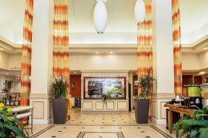 a lobby of a hotel with potted plants at Hilton Garden Inn Oshkosh in Oshkosh +168 photos