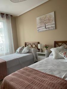 Ένα ή περισσότερα κρεβάτια σε δωμάτιο στο Piso Ortigueira Centro