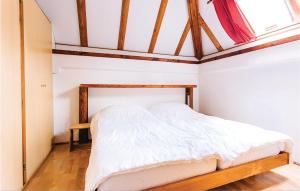 an attic bedroom with a bed with white sheets at Ferienhaus 22 In Frankenau in Frankenau