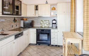 a kitchen with white cabinets and a stove top oven at Pet Friendly Home In Oberaula-Hausen in Hausen