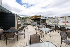 a patio with tables and chairs on a deck at Coast High Country Inn in Whitehorse
