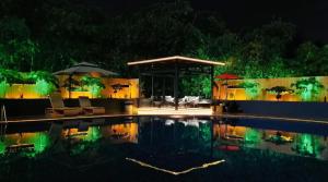 a swimming pool at night with a gazebo and chairs at Guilin Plaza Hotel in Guilin