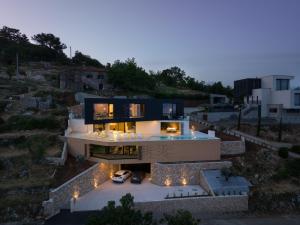 una vista aérea de una casa con luces en Villa 3,0 near Opatija for 8 people with indoor and outdoor pool & wellness, en Opatija