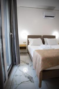 a bedroom with two beds and a window at Star Hotel in Rhodes Town
