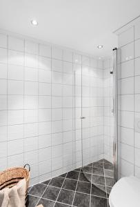 a bathroom with a shower with a glass door at Cozy nest- walking distance to city center in Bergen