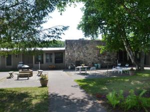 a patio with tables and chairs in front of a building at Birchwood Inn in Harbor Springs