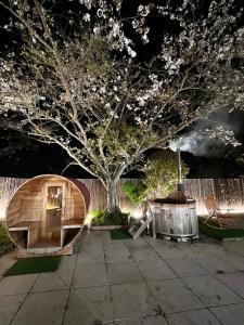 a wooden hobbit house in front of a tree at Asahi Sanso - Vacation STAY 16835 in Sosa