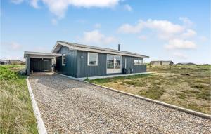 a green house with a gravel driveway at Holiday Home Hvide Sande 31 in Bjerregård +17 photos