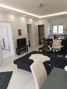 a living room with a bed and a couch at Lake House Comfort in Zamárdi
