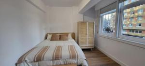 Ένα ή περισσότερα κρεβάτια σε δωμάτιο στο Precioso apartamento CORUÑA - recién reformado