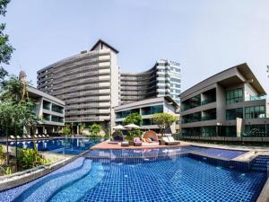 a swimming pool in front of some buildings at Green Valley Executive Serviced Residence in Chiang Mai