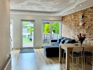 a living room with a couch and a table at Villa Blue Sky in Heinkensand