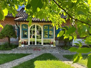 a home with a brick house with a large window at Wilaneska Prośno in Prośno