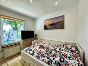 a bedroom with a bed with a teddy bear on it at Villa Blue Sky in Heinkensand +131 photos