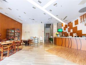 a lobby of a restaurant with tables and a counter at Metropolo Hotel Financial Street Wanda Plaza in Fuzhou