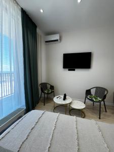 アクタウにあるAktau Riviera Актауのベッドと薄型テレビのある寝室