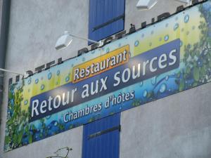 a street sign for a restaurant return aix surprises at Retour Aux Sources in Meyras