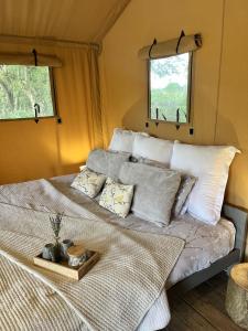 a bedroom with a bed with a tray on it at Kingfisher Safari Tent in Droitwich