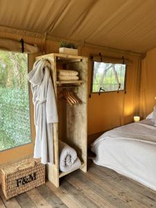 a bedroom with a bed in a tent at Kingfisher Safari Tent in Droitwich