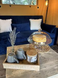 a coffee table with a cake on top of it at Kingfisher Safari Tent in Droitwich +9 photos