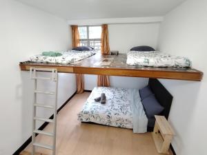 two bunk beds in a room with a ladder at Venice Hill Cheras Young Forever Homestay in Cheras +16 photos