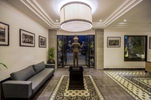 a living room with a couch and a statue at The Cyclo Siem Reap Hotel in Siem Reap +104 photos