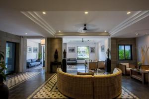a living room with a couch and a table at The Cyclo Siem Reap Hotel in Siem Reap