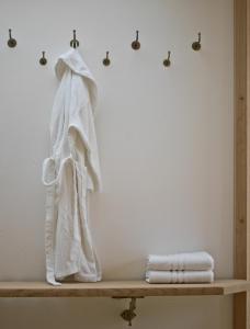 a white towel on a shelf in a bathroom at Biohotel Pausnhof in Sankt Oswald