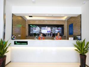 two women standing at the counter of a restaurant at Vatica Beijing Tongzhou Liyuan Universal Studios in Beijing