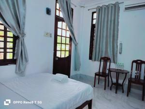 En eller flere senge i et værelse på DIỆP NGỌC MAI Guest House