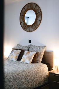 a bedroom with a bed with a mirror on the wall at Le Cocon Capestanais in Capestang +23 photos