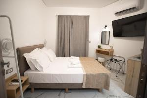 a hotel room with a bed and a television at Star Hotel in Rhodes Town
