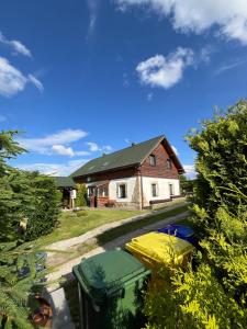 a house with two bins in front of it at Chata Nikol in Oravská Lesná