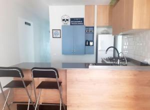 a kitchen with a counter with two stools in it at Vacation house in the mountains in Esparraguera +4 photos