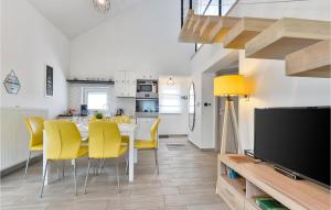 a dining room with a table and yellow chairs at Gorgeous Home In Cresnjevec, Tuhelj in Tuheljske Toplice