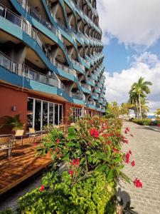 a building with a bunch of flowers in front of it at Kingreal seaview resort sanya in Sanya