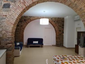 an archway in a living room with a blue couch at A 20 passi dal mare in Giardini Naxos