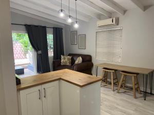 a kitchen and living room with a couch and a table at Familia in Pietermaritzburg