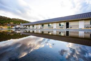 a reflection of a building in a body of water at OYO Riverside Inn John Day OR in John Day