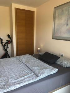 a bedroom with a bed and a bike in the corner at Apartment Panoramica Golf in Sant Jordi +20 photos