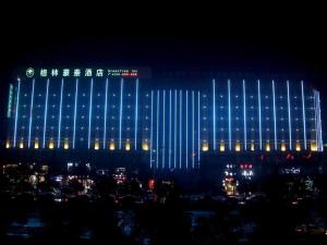 a building with blue lights on it at night at GreenTree Inn Suzhou Yongqiao District Jinhai Avenue Branch in Suzhou